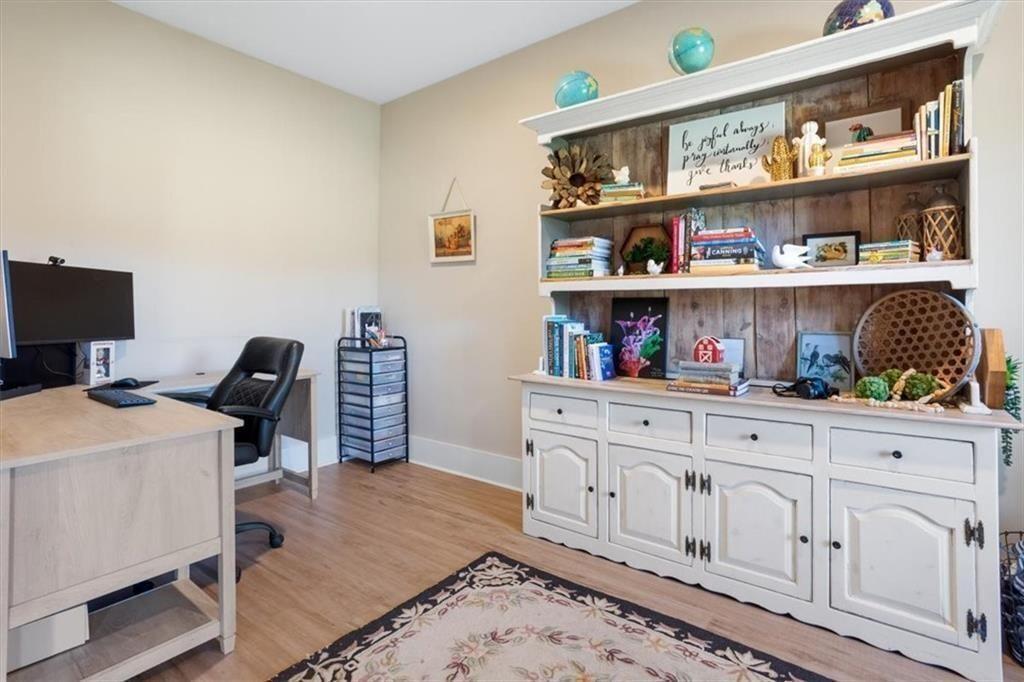 14402 Fincher Road Ball Ground, GA 30107 - Photo 26 of 55 a room with furniture a rug and a book shelf