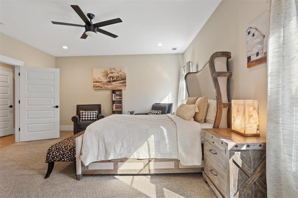 14402 Fincher Road Ball Ground, GA 30107 - Photo 29 of 55 a bedroom with a bed and a chandelier