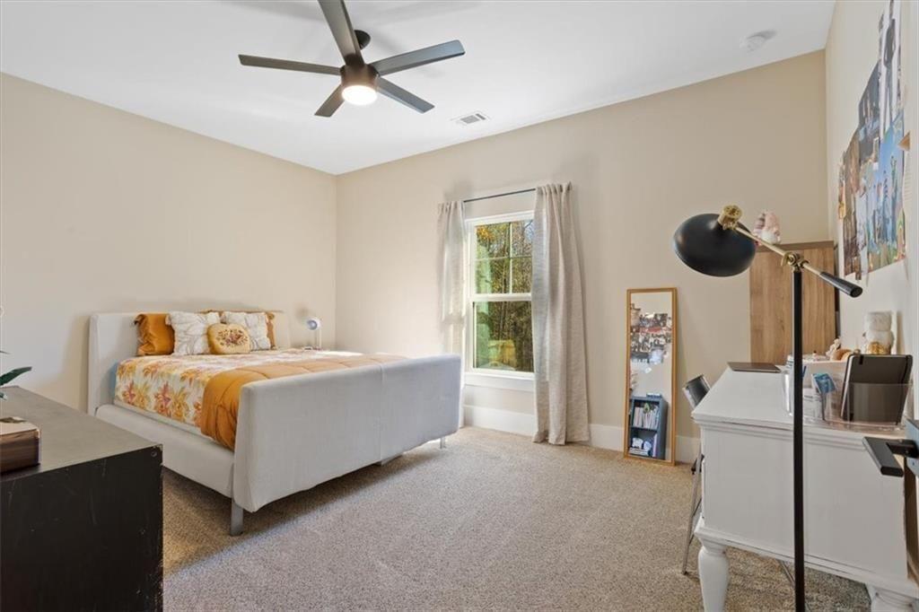 14402 Fincher Road Ball Ground, GA 30107 - Photo 38 of 55 a white bed sitting in a bedroom next to a window