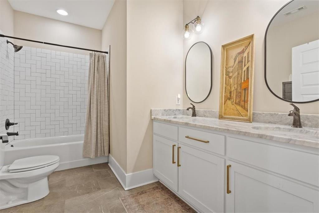 14402 Fincher Road Ball Ground, GA 30107 - Photo 40 of 55 a bathroom with a double vanity sink toilet and shower