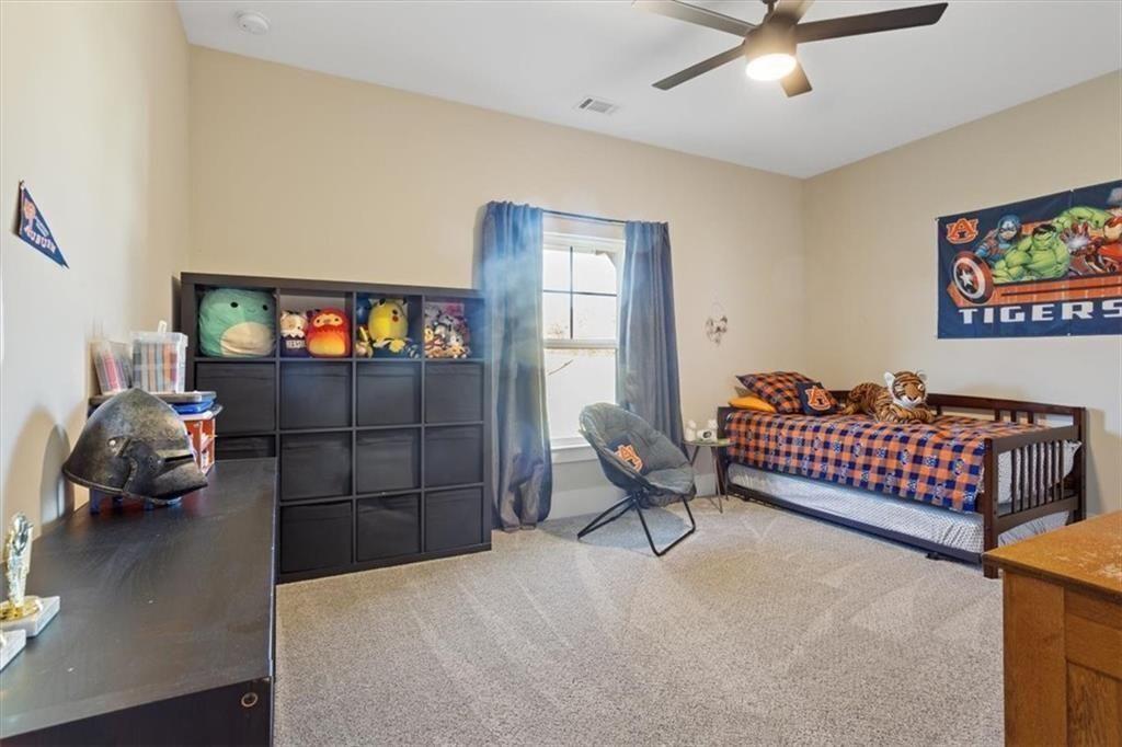 14402 Fincher Road Ball Ground, GA 30107 - Photo 42 of 55 a bedroom with furniture and a window