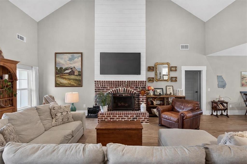 14402 Fincher Road Ball Ground, GA 30107 - Photo 9 of 55 a living room with furniture a fireplace and a flat screen tv