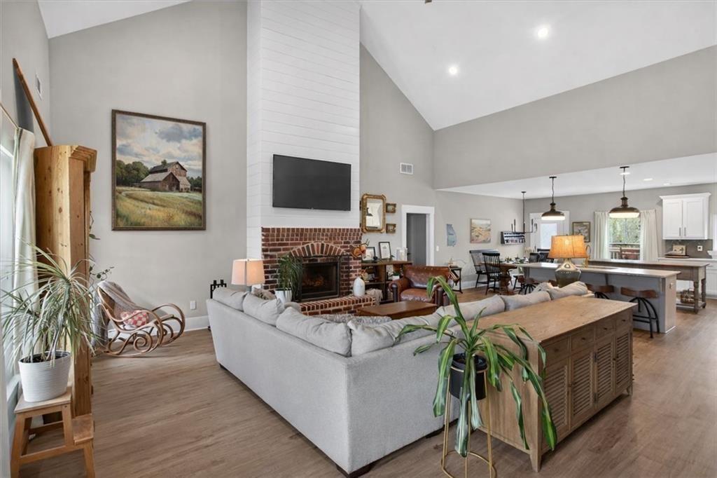 14402 Fincher Road Ball Ground, GA 30107 - Photo 10 of 55 a living room with furniture a flat screen tv and a fireplace