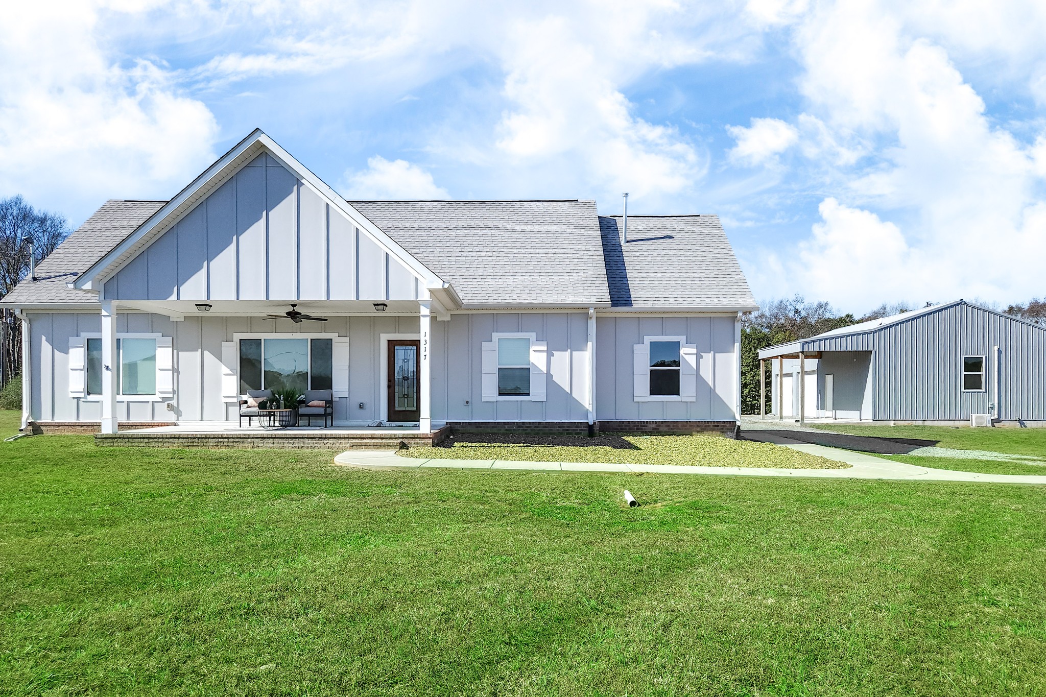 a front view of a house with a garden