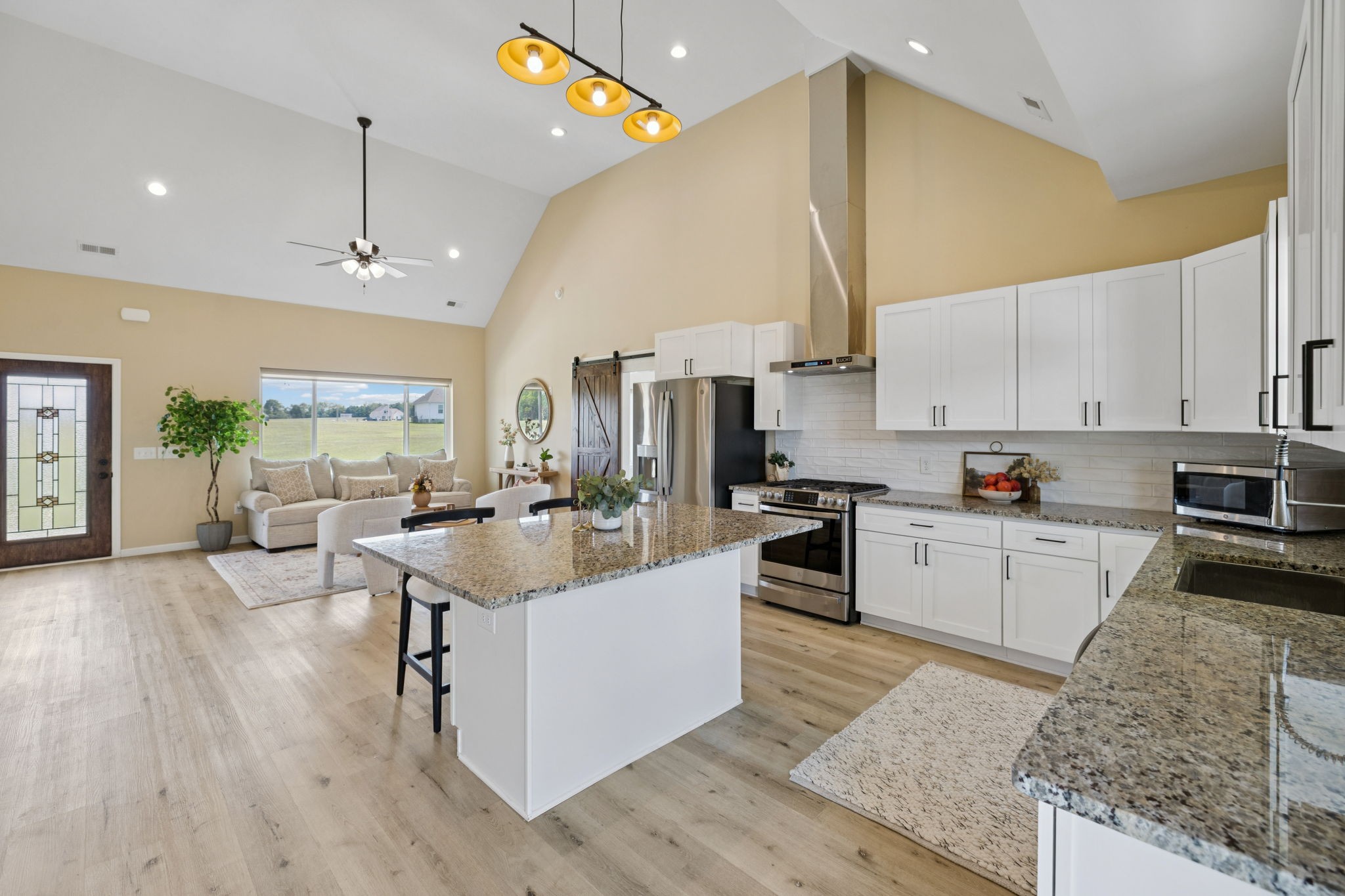 1317 Halls Mill Road Unionville, TN 37180 - Photo 12 of 41 a living room with stainless steel appliances kitchen island granite countertop a sink dishwasher a stove and a refrigerator with wooden floor