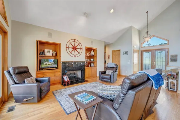 a view of a dining room with furniture wooden floor and chandelier