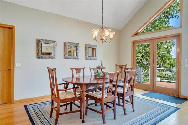 a kitchen with stainless steel appliances granite countertop wooden cabinets a sink and dishwasher a stove with wooden floor