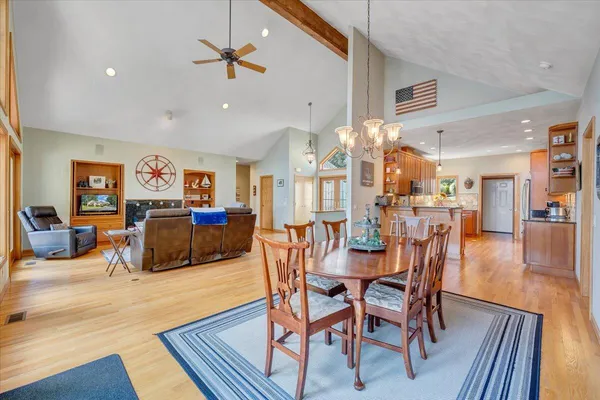 a kitchen with stainless steel appliances granite countertop a refrigerator a stove and a sink with cabinets