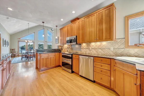a room with pool table and windows