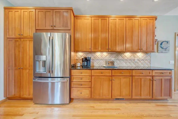 a spacious bathroom with a double vanity sink a mirror and a toilet