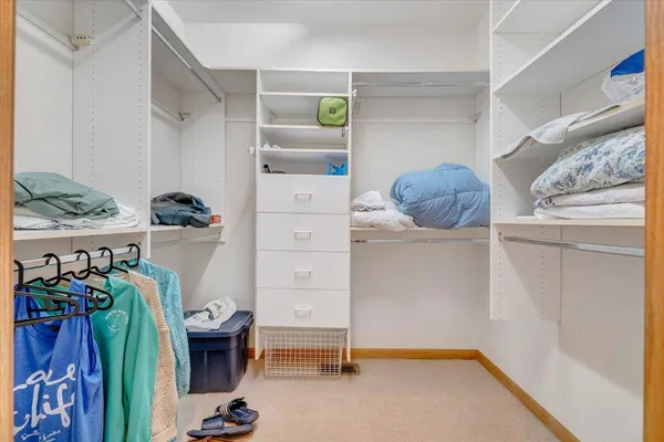 a view of a roof deck with table and chairs with wooden floor and fence