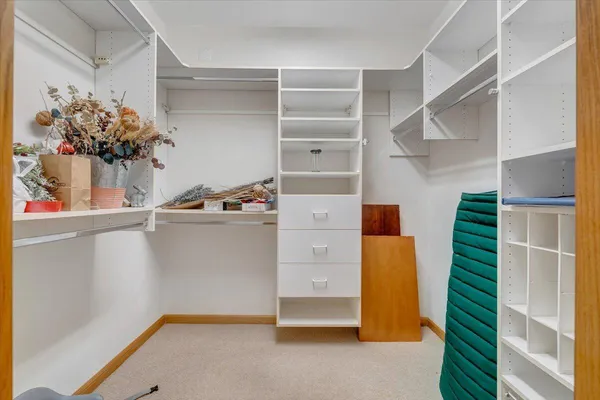 a view of a roof deck with chair and wooden floor