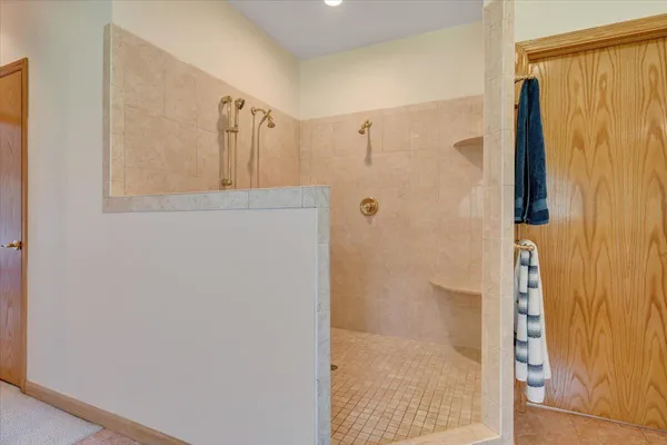 a front view of a house with a garden and trees