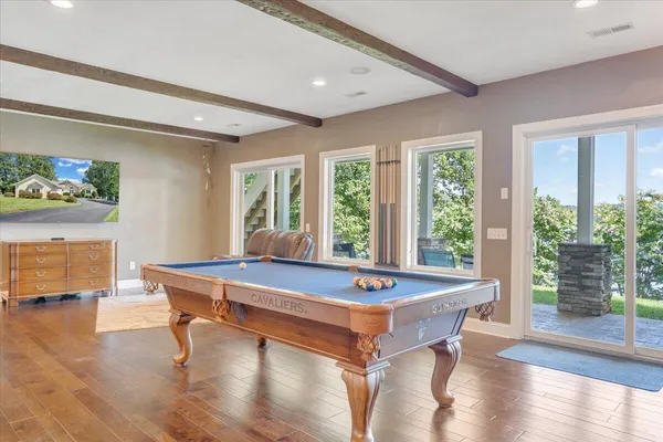 an aerial view of a house with a yard basket ball court and outdoor seating