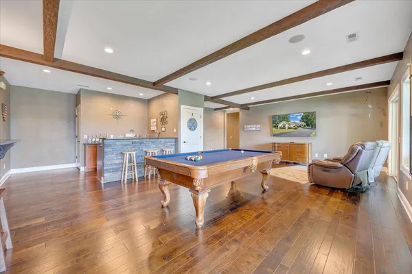 an aerial view of a house with a yard and lake view