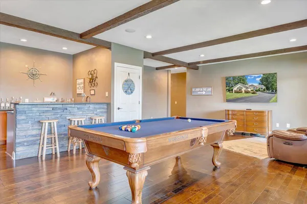 an aerial view of residential houses with outdoor space and lake view