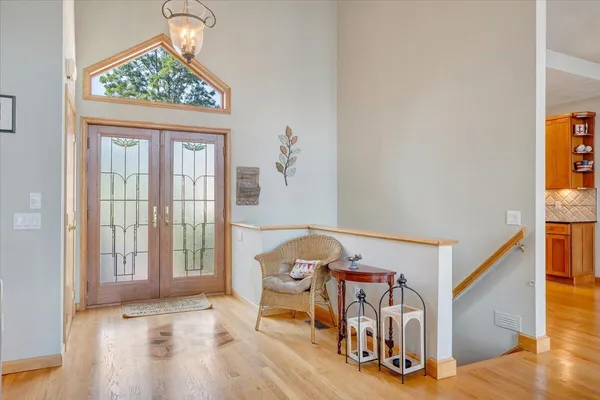 a living room with furniture a flat screen tv and wooden floor