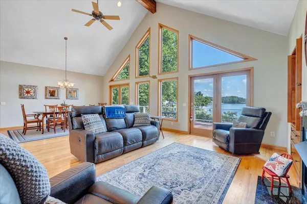 a view of a dining room with furniture a chandelier and wooden floor