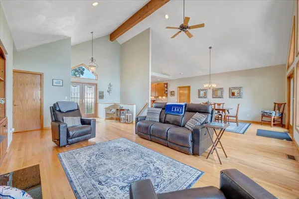 a view of a dining room with furniture large window and wooden floor