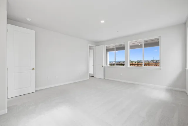 a view of an empty room with kitchen