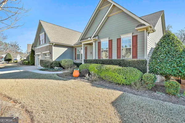 a front view of a house with a yard and outdoor seating