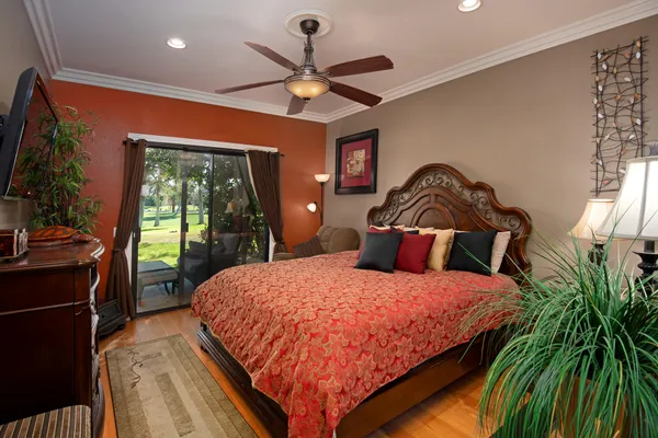 a bedroom with a bed and a chandelier