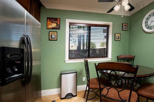 a view of a dining room with furniture and a window
