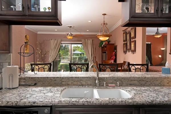a kitchen with granite countertop sink and cabinets