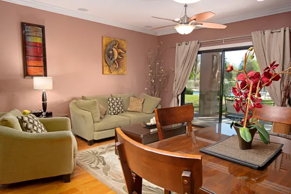 a living room with furniture and a potted plant