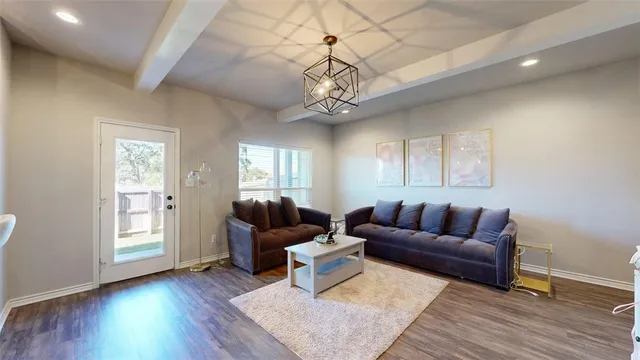 a living room with furniture a wooden floor and a window