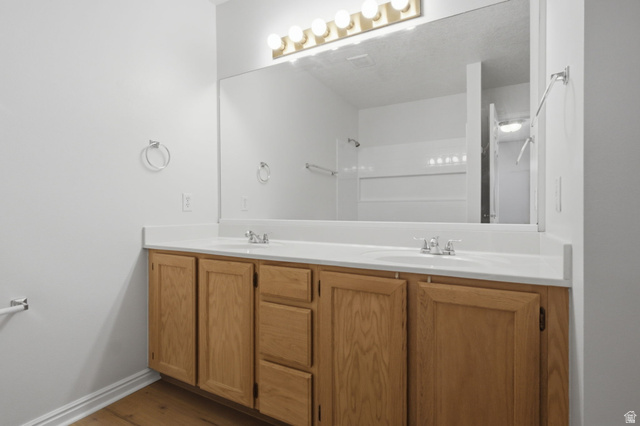 794 East 950 S Street Provo, UT 84606 - Photo 18 of 28 Double vanity with light wood cabinetry, white countertops, and chrome fixtures