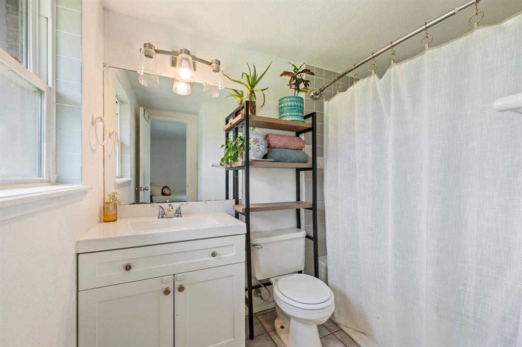3900 Moseley Road Cross Roads, TX 76227 - Photo 13 of 36 White vanity with integrated sink and chrome faucet
