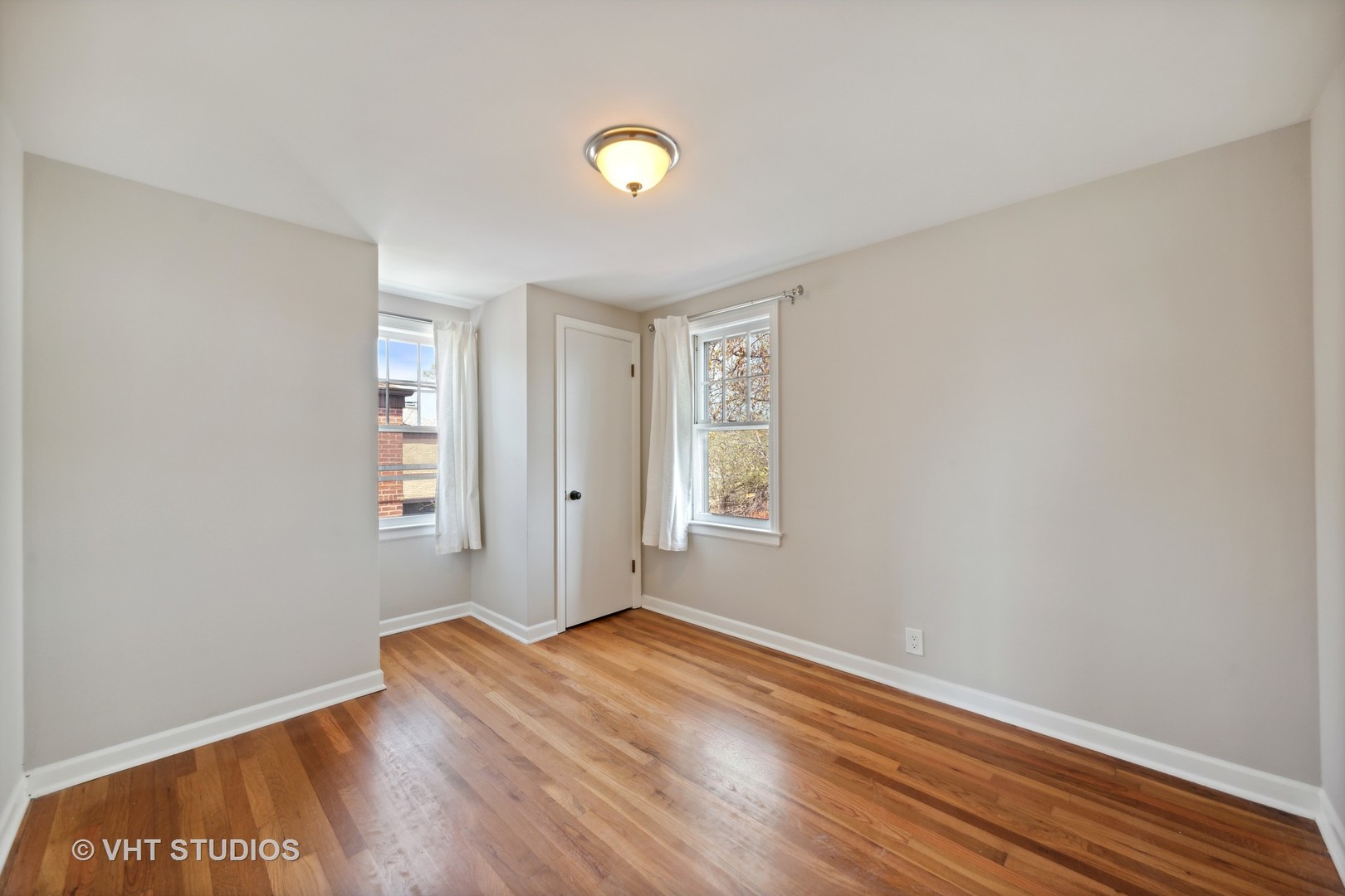 7424 West Gregory Street Chicago, IL 60656 - Photo 11 of 17 an empty room with wooden floor and windows