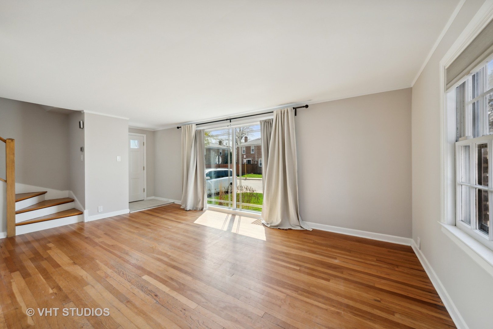 7424 West Gregory Street Chicago, IL 60656 - Photo 3 of 17 a view of an empty room with wooden floor and a window