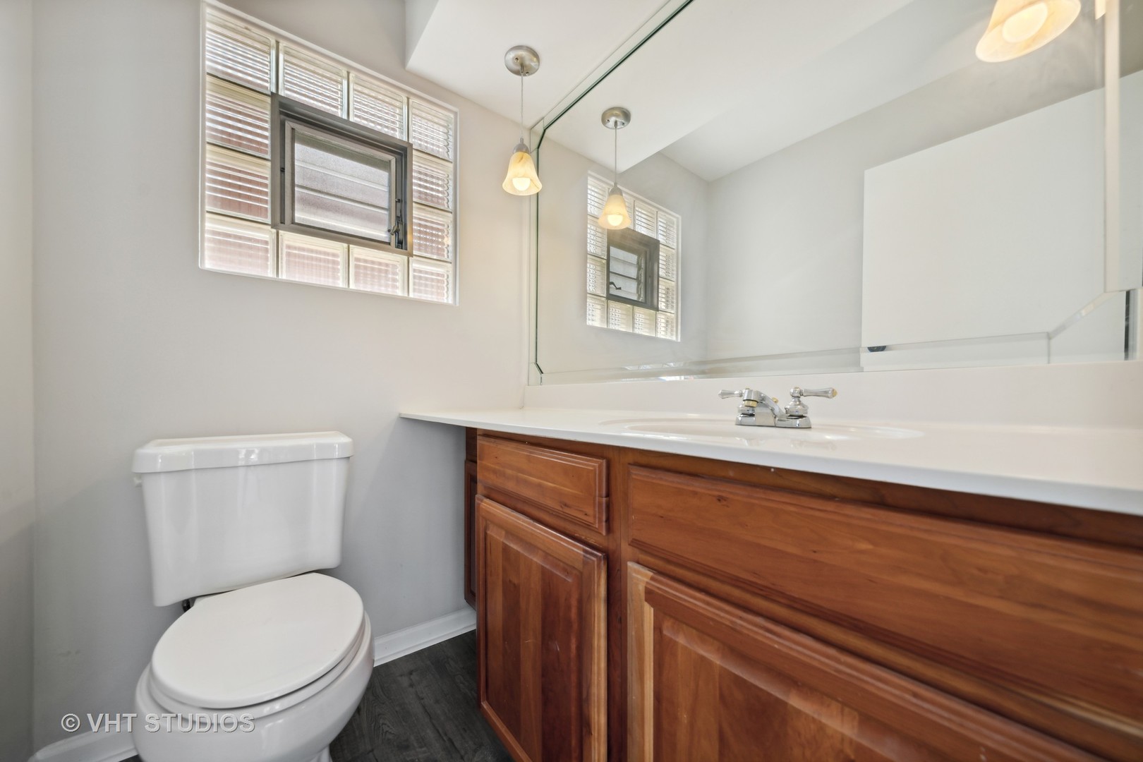 7424 West Gregory Street Chicago, IL 60656 - Photo 9 of 17 a bathroom with a toilet a sink and mirror