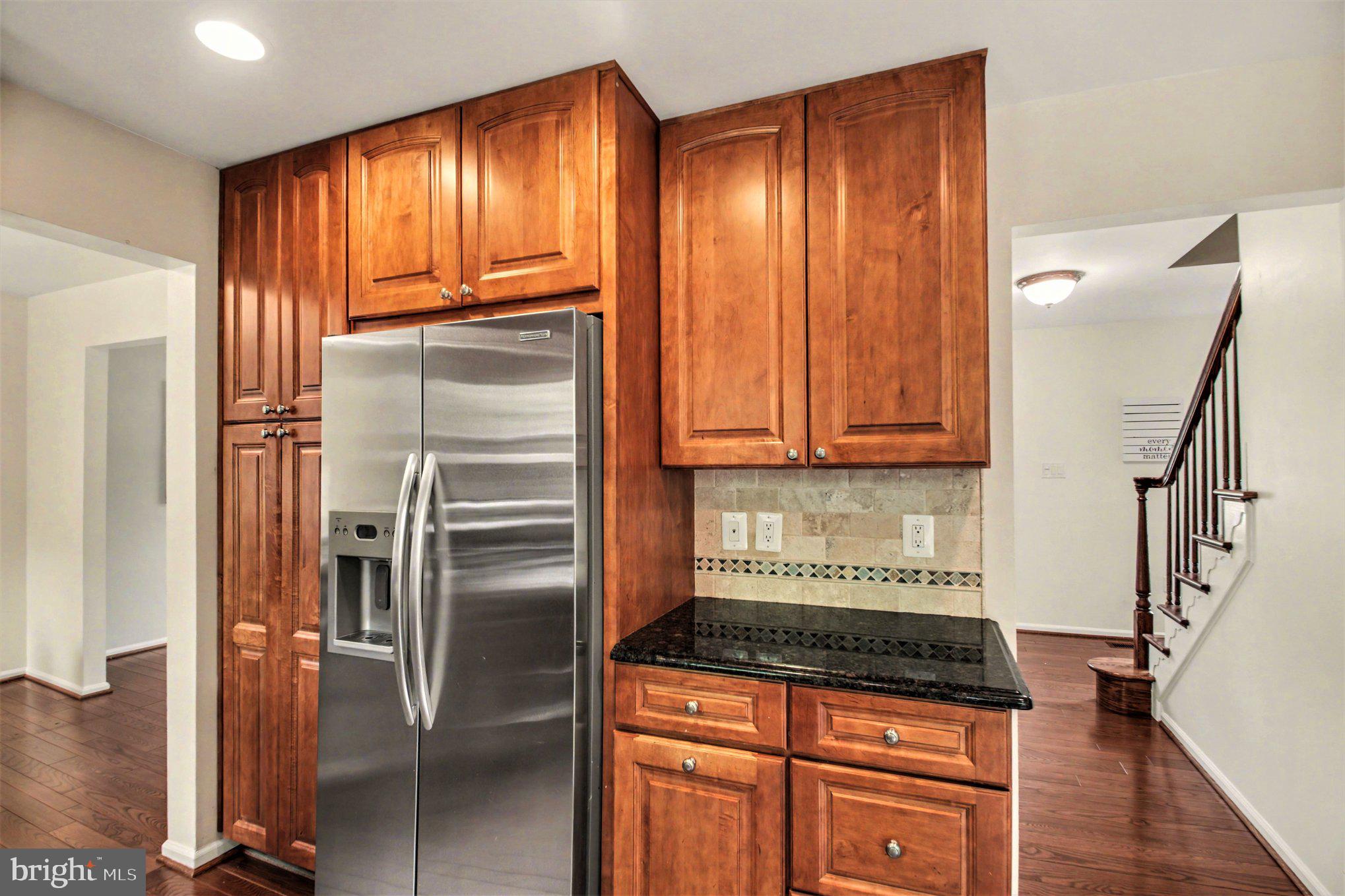 8309 Timber Brook Lane Springfield, VA 22153 - Photo 11 of 39 a kitchen with granite countertop a refrigerator and a sink