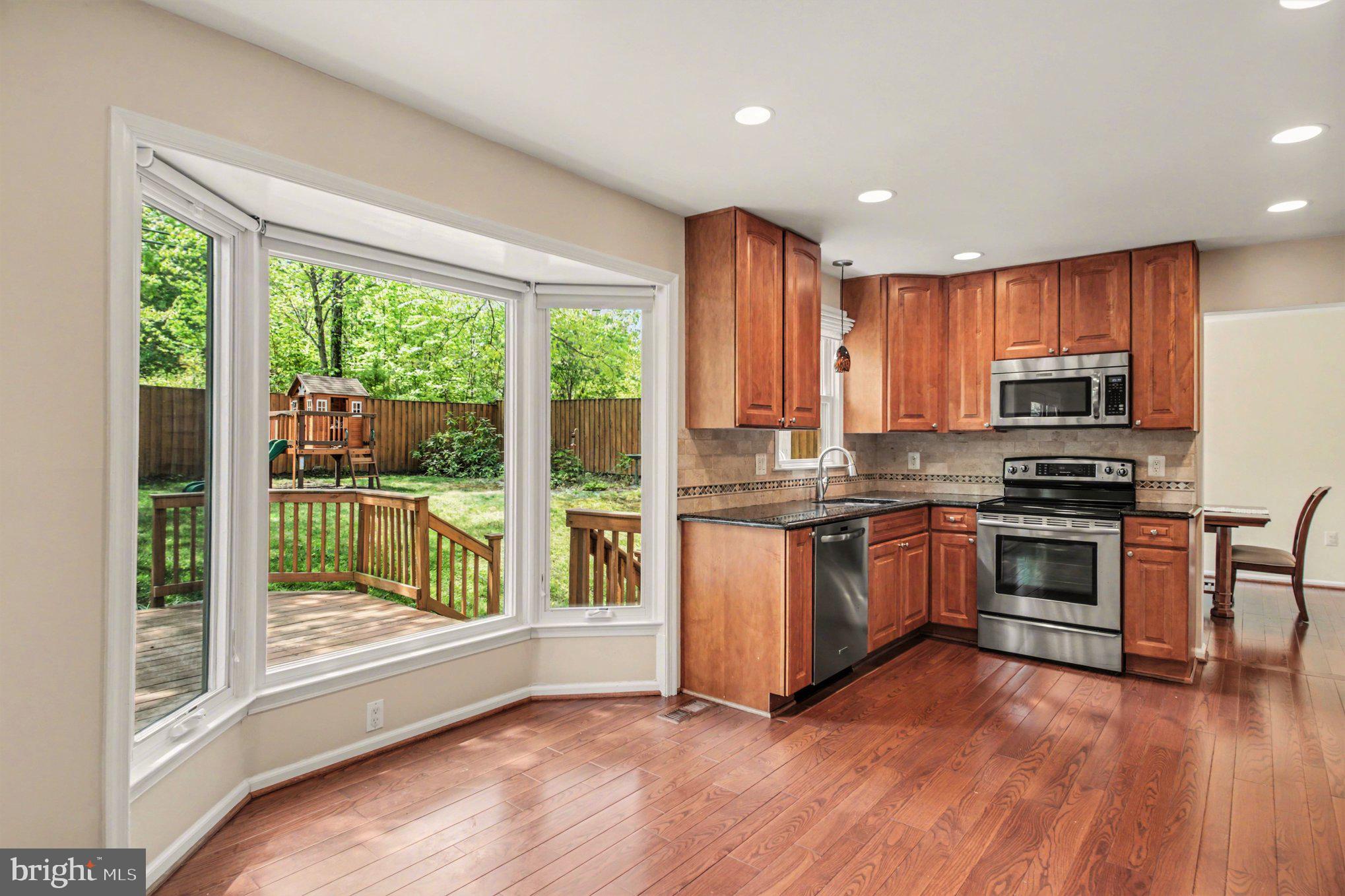 8309 Timber Brook Lane Springfield, VA 22153 - Photo 13 of 39 a kitchen with stainless steel appliances granite countertop a stove a sink and a refrigerator