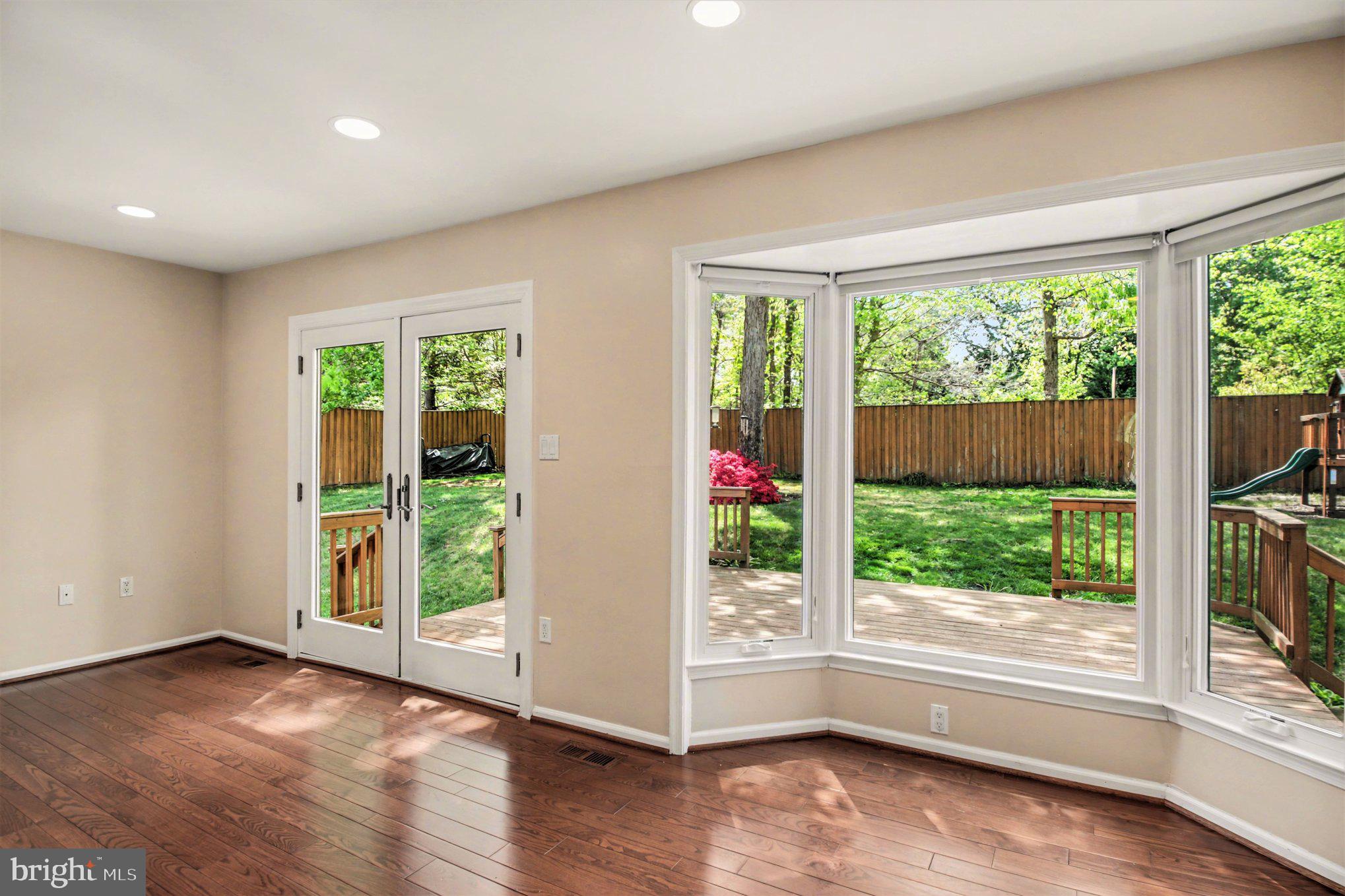 8309 Timber Brook Lane Springfield, VA 22153 - Photo 15 of 39 a view of an empty room with wooden floor and a window