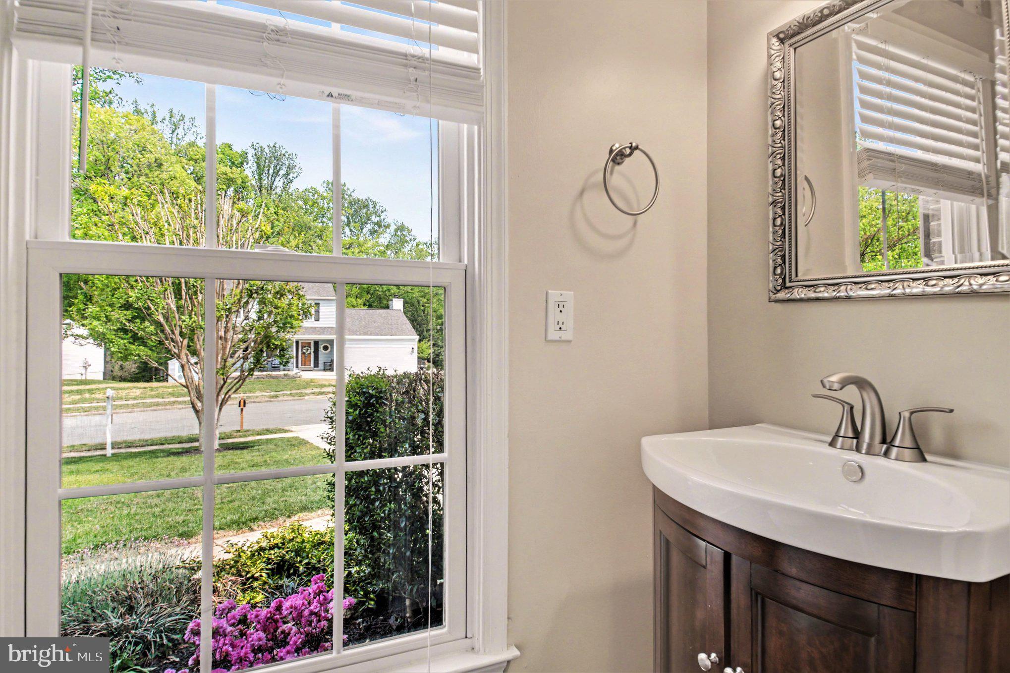8309 Timber Brook Lane Springfield, VA 22153 - Photo 17 of 39 a bathroom with a sink vanity and window