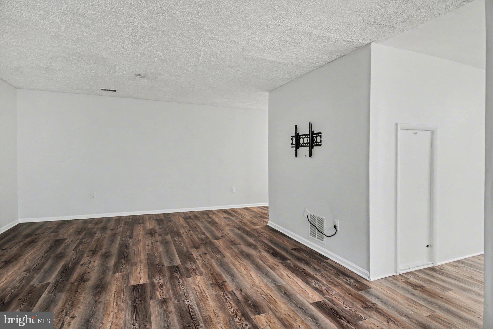 8309 Timber Brook Lane Springfield, VA 22153 - Photo 30 of 39 a view of a room with wooden floor and a ceiling fan