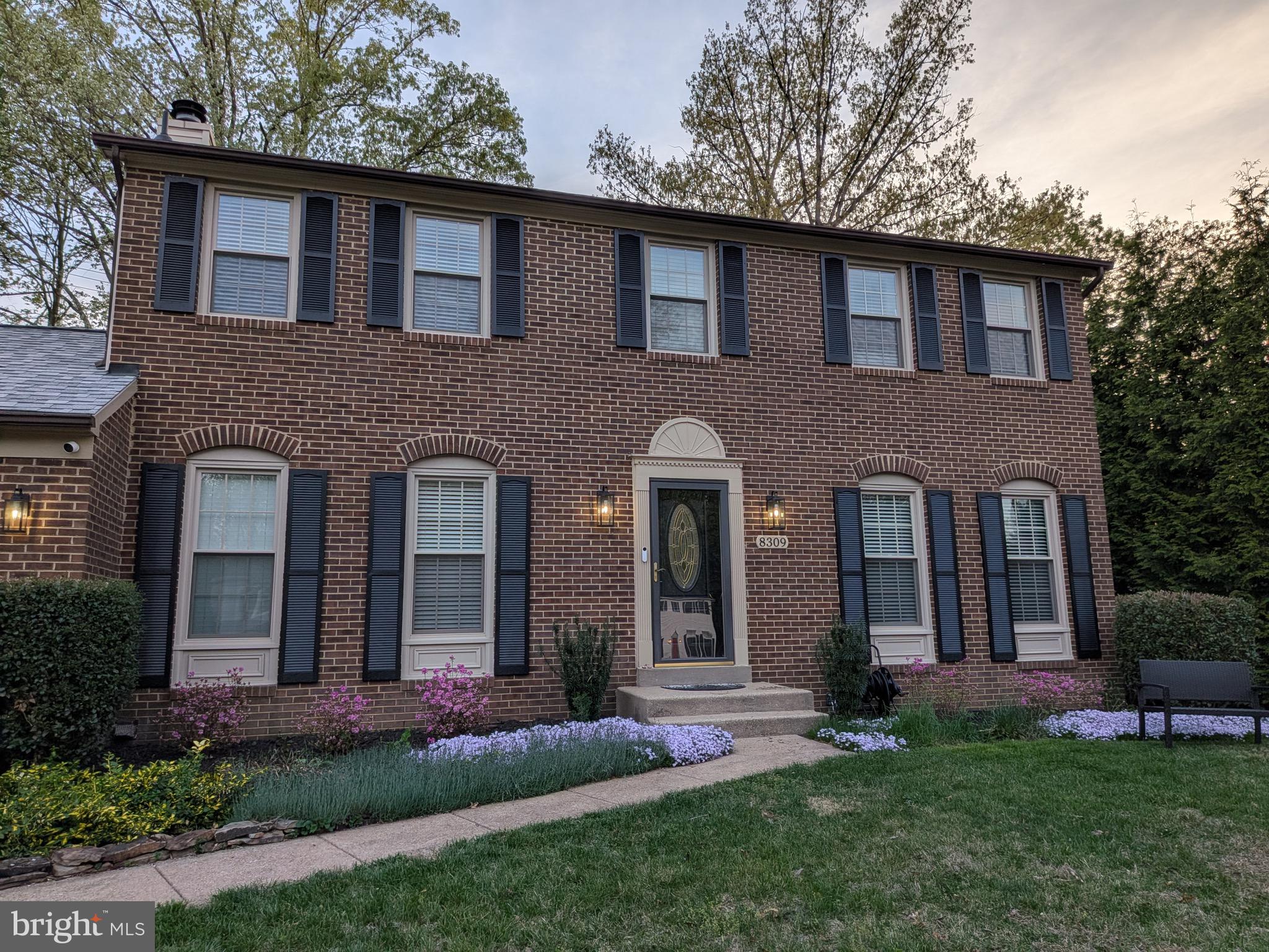 8309 Timber Brook Lane Springfield, VA 22153 - Photo 3 of 39 a front view of a house with a garden and yard