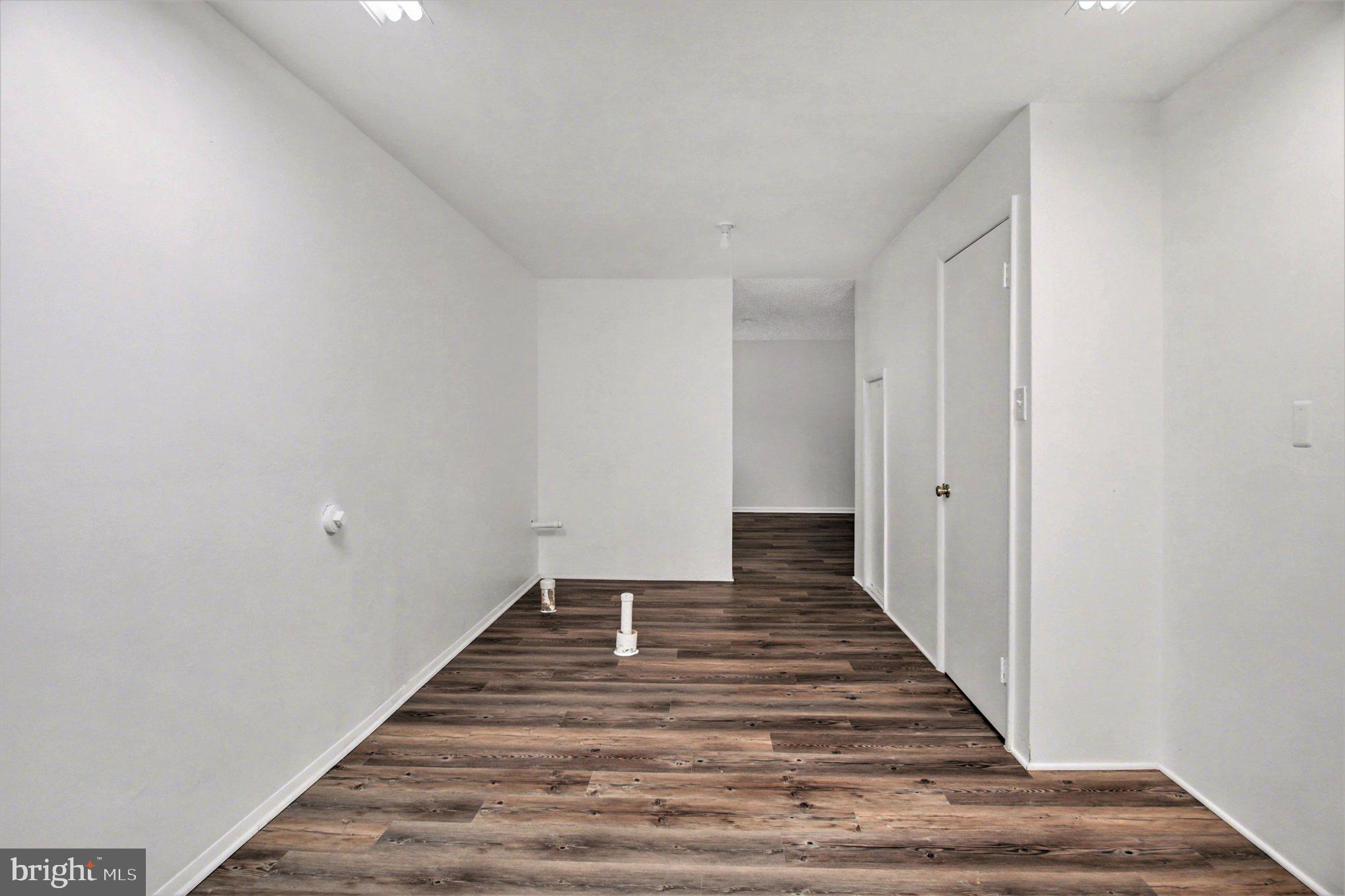 8309 Timber Brook Lane Springfield, VA 22153 - Photo 31 of 39 a view of a hallway with wooden floor and staircase