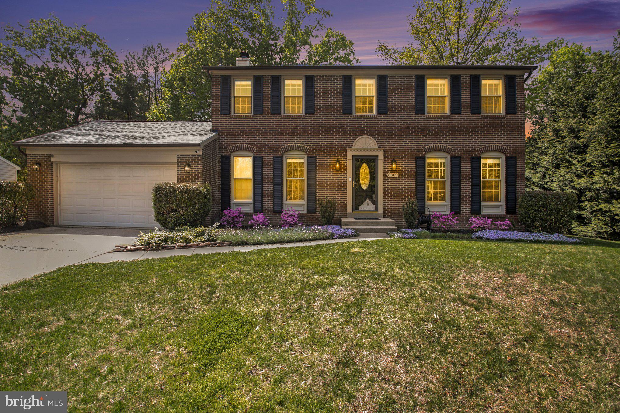 8309 Timber Brook Lane Springfield, VA 22153 - Photo 4 of 39 front view of a brick house with a yard