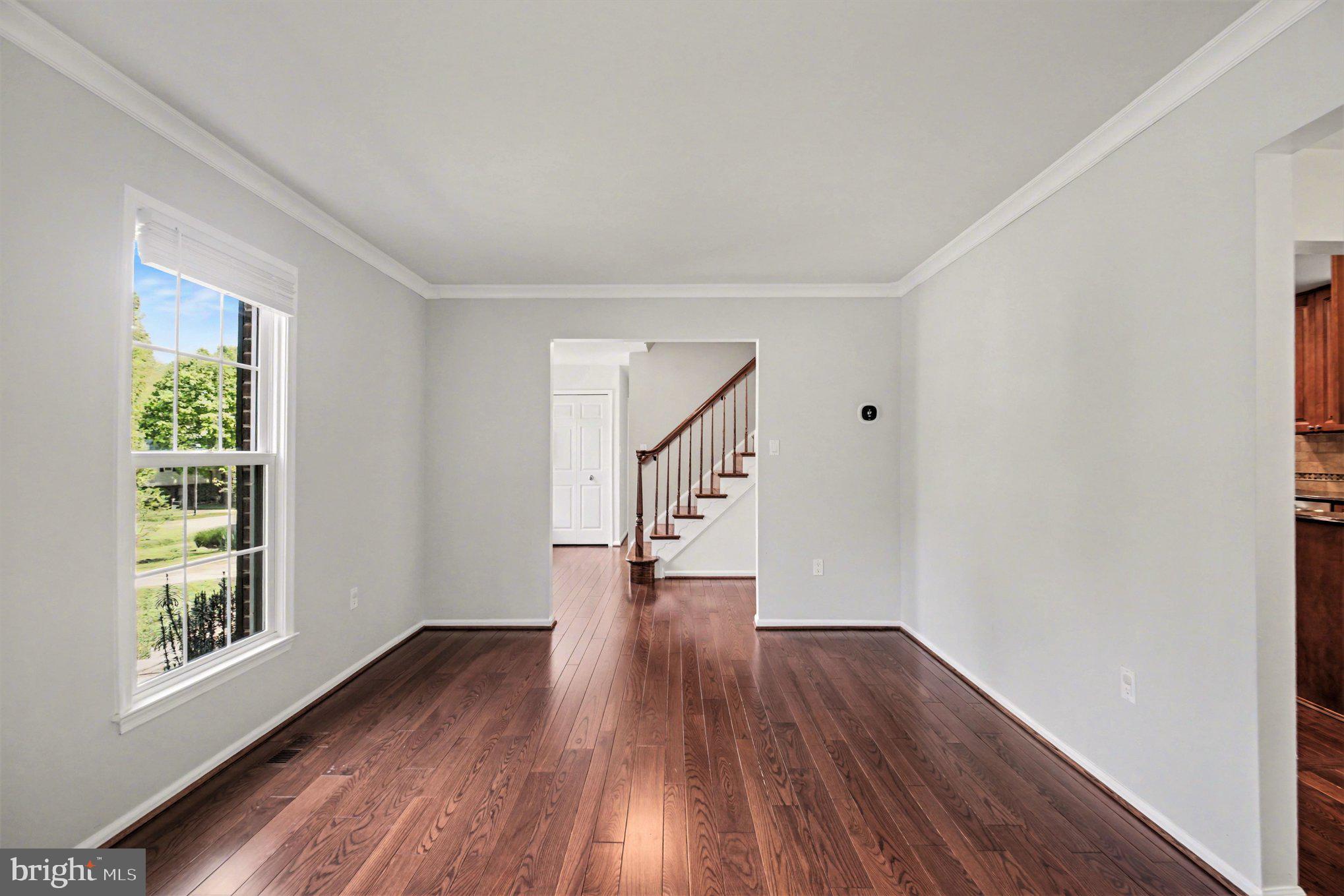 8309 Timber Brook Lane Springfield, VA 22153 - Photo 6 of 39 a view of empty room with wooden floor and fan