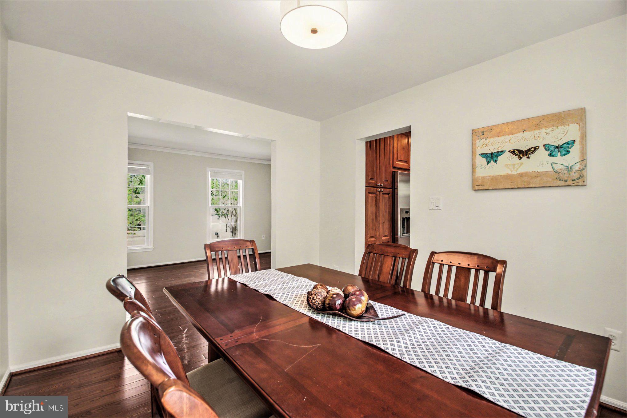 8309 Timber Brook Lane Springfield, VA 22153 - Photo 8 of 39 a view of a dining room with furniture and wooden floor