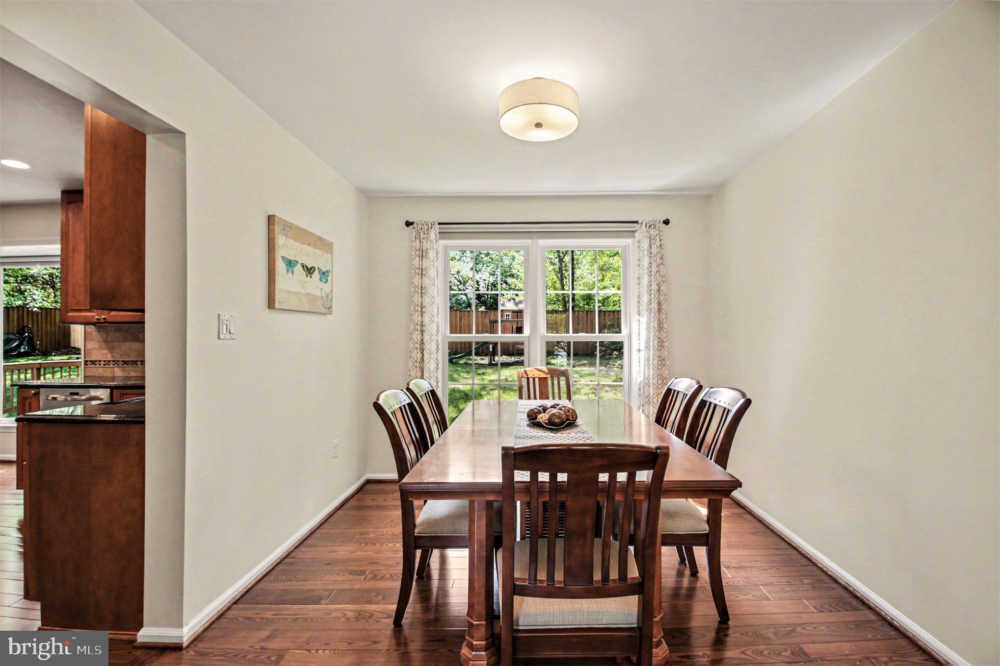 8309 Timber Brook Lane Springfield, VA 22153 - Photo 9 of 39 a view of a dining room with furniture window and wooden floor