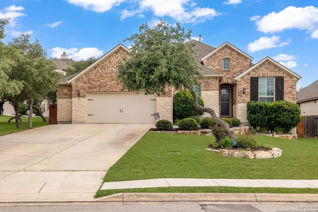 a front view of a house with a yard and garage