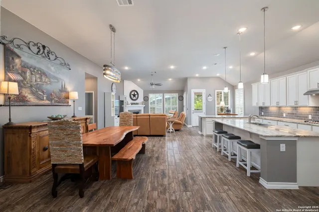 a large kitchen with a table and chairs