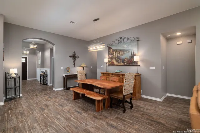 a view of a a dining room with furniture window and wooden floor
