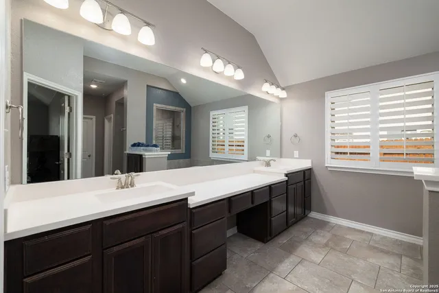 a bathroom with a sink vanity and a mirror